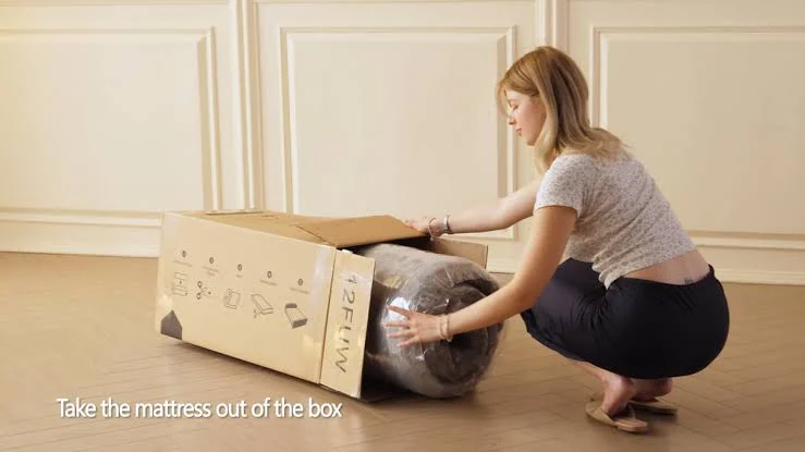 Mattress being removed from a box